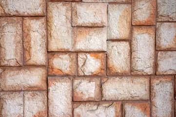 Fototapeta premium The texture of the wall of the large beige stones