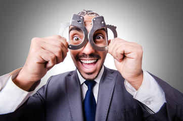 Funny businessman with handcuffs on white