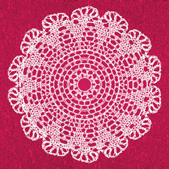 Elegant lacy doily on canvas.