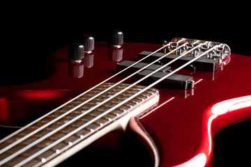 Naklejka premium Bass guitar close-up. Photo in low key