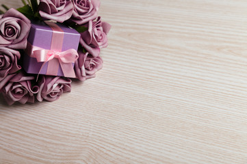 Purple roses and gift box