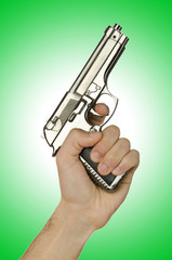 Naklejka premium Gun in the hand on white