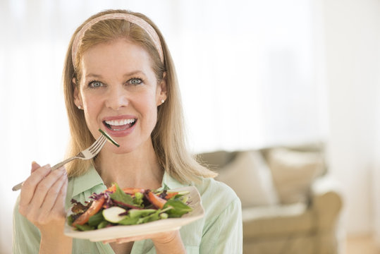 Smiling Mature Woman Having Healthy Salad At Home