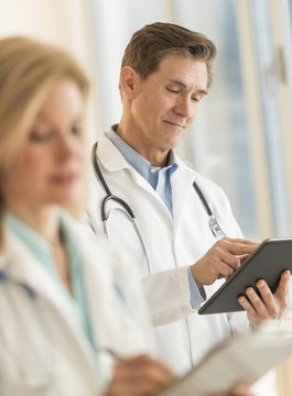 Male Doctor Using Digital Tablet At Hospital
