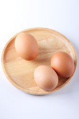raw eggs on wood plate
