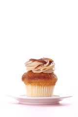 cupcake with frosting on white plate