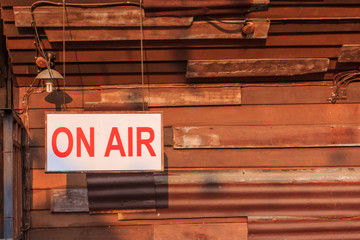 ON AIR sign light box hang on old wood background old.
