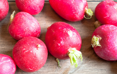 Freshly harvested radishes on a wooden surface