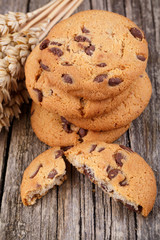 Tasty cookies with wheat on a wooden table.