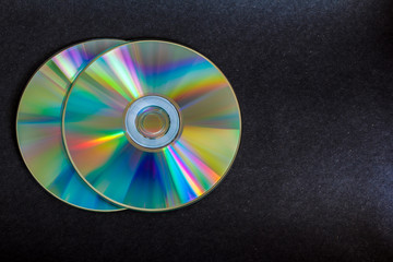 compact discs and digital versatile disc on a black background