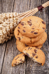 Tasty cookies with wheat on a wooden table.