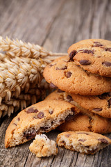 Tasty cookies with wheat on a wooden table.