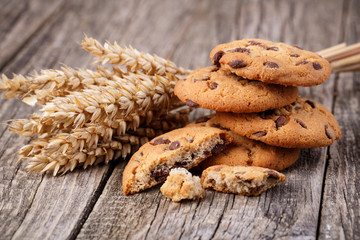 Tasty cookies with wheat on a wooden table.
