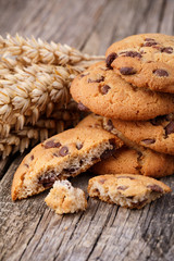 Tasty cookies with wheat on a wooden table.
