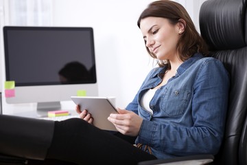 Puzzled businesswoman studying her tablet