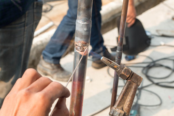 Plumbing contractor works sweating