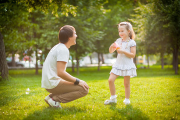 Naklejka na ściany i meble girl with her father in the park
