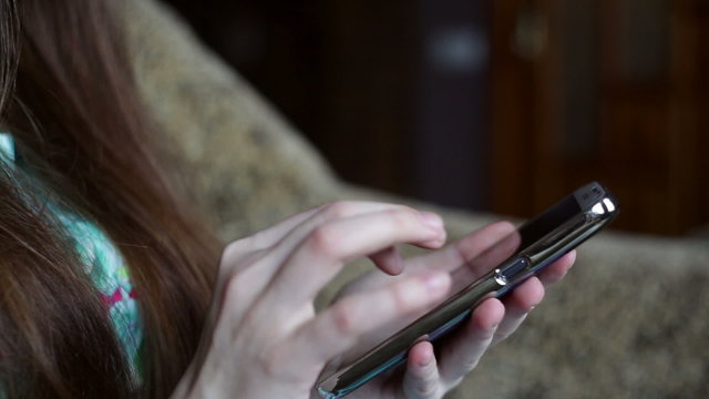 girl holding a smartphone. Close-up