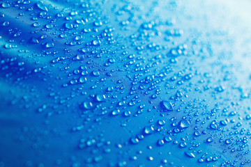 Water droplets on blue fiber