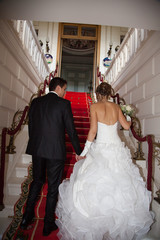 Newly wed couple climbing stairs