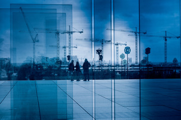 Silhouette of a crane group through glass blocks