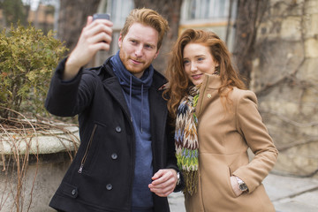 Couple taking photo with mobile phone