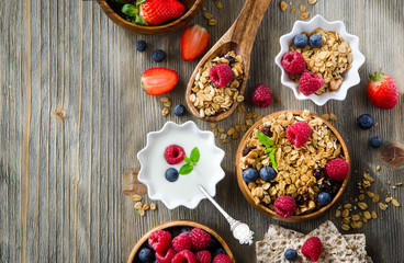 Obraz na płótnie Canvas Fresh healthy breakfast with granola and berries, copy space bac