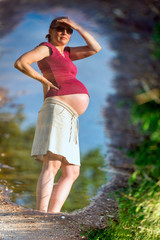 Outdoor natural portrait of beautiful pregnant woman