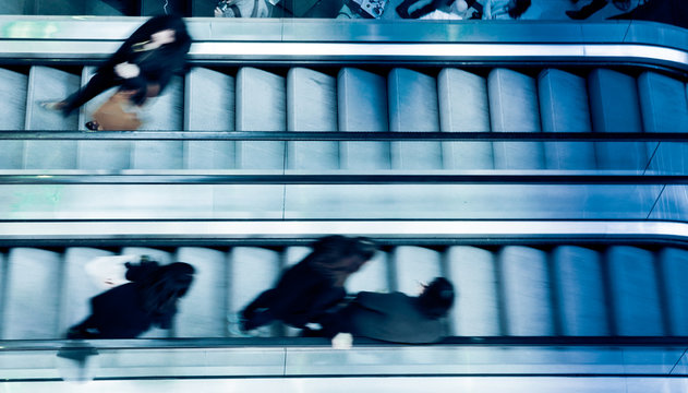 People On Crossing Escalators