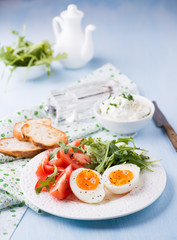 Breakfast with soft-boiled egg, arugula and tomatoes