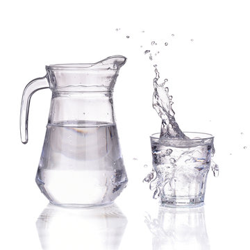 Fresh water glass with splash and bottle isolated
