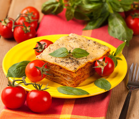 Tasty flavorful lasagna on a plate and ingredients