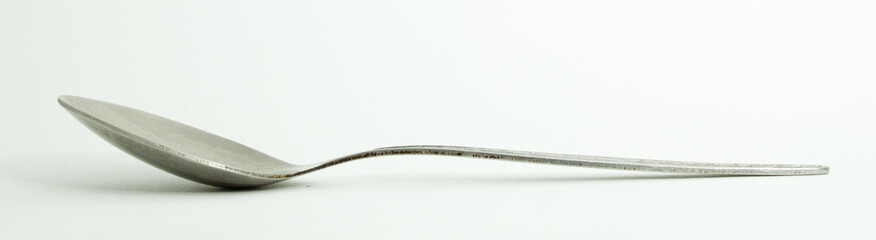 Metal and wood spoon in profile