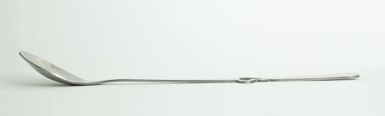 Metal and wood spoon in profile