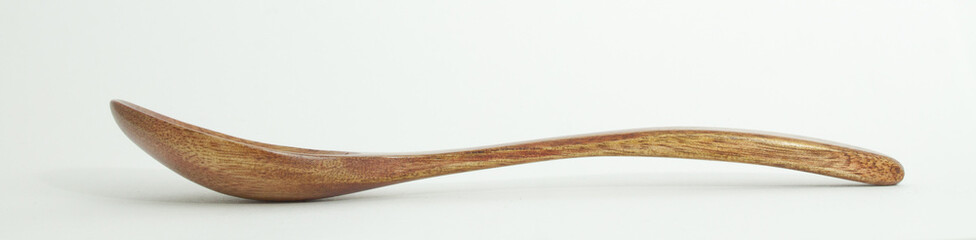 Metal and wood spoon in profile