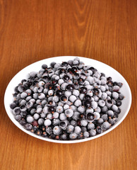 Frosted black currant in a plate