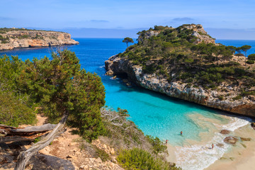 Couple of people on Cala des Moro beach, Majorca island, Spain