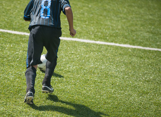 child plays football