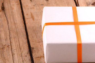 white gift box on wooden plate