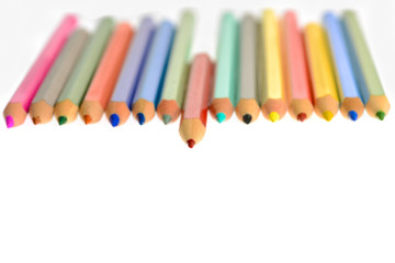 Front view of aligned coloring crayons isolated