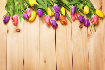 Spring Flowers bunch at wood floor texture. Beautiful Tulips bou