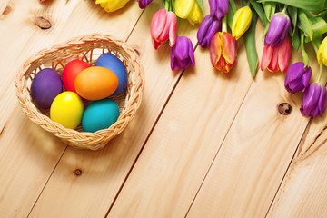 Spring Flowers bunch and easter eggs at wood floor texture. Beau