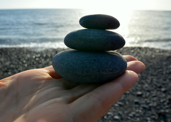 Hand holding stones.