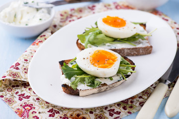 Rye toast sandwiches with egg and soft cheese