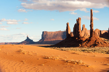 Totem pole rocks and sand dunes in Monument valley tribal park
