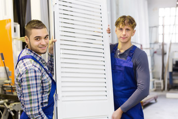 Naklejka na ściany i meble workers in coverall with PVC window with shutter