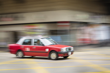 Fototapeta na wymiar Motion blurred Taxi in Hong Kong.