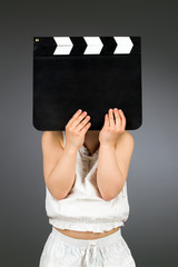 Kid holding clapper board