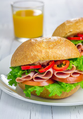Healthy sandwiches with ham and a glass of orange juice
