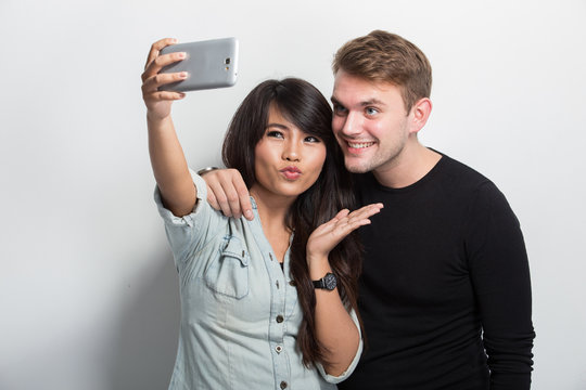  Happy Young Multiculture Couple taking self camera together